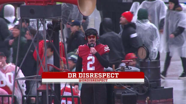 A weirdly-dressed man on a microphone.