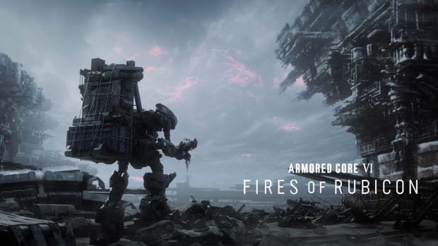 A large bipedal robot with a metallic backpack is standing amid a heap of metal scrap, near a tall structure that looks as if it's suffered explosion damage. In front of the robot is a cloudy sky streaked with pink