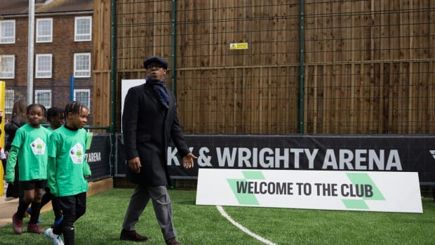 Ian Wright walking onto a pitch.
