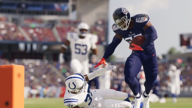 Madden 23 player runs for a touchdown as another player falls down.