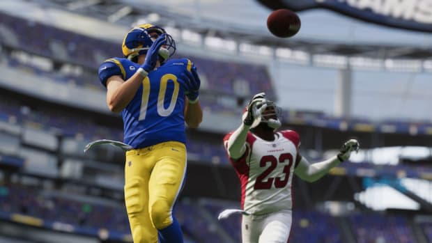 Two opposing players go for the catch in Madden 23.