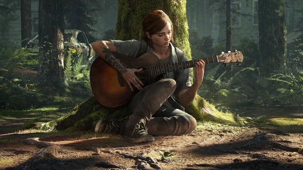 The Last of Us 2's Ellie is sitting in front of a large, moss-covered tree, playing a guitar