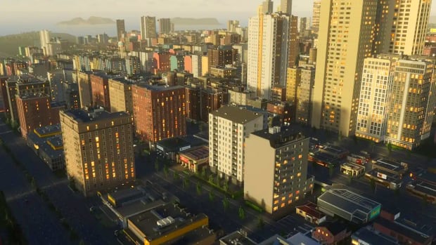 A Cities Skylines 2 horizon, with highrises and skyscrapers dominating the view, lit by the evening sun