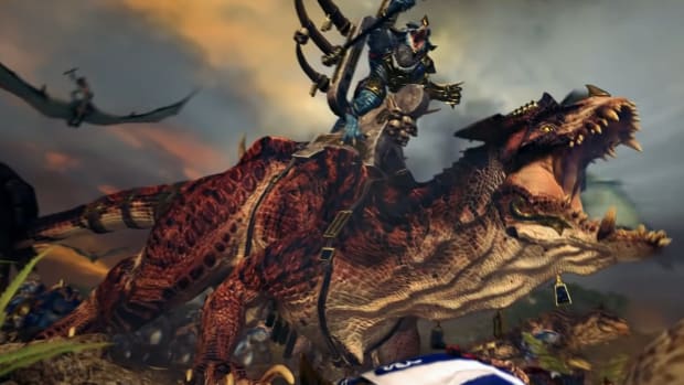 Total War: Warhammer 2 trailer screenshot showing a Lizardman riding a giant carnosaur.