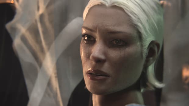 A character from The Sinking City 2, a woman with gray skin and short white hair, is shown crying and looking at the player character