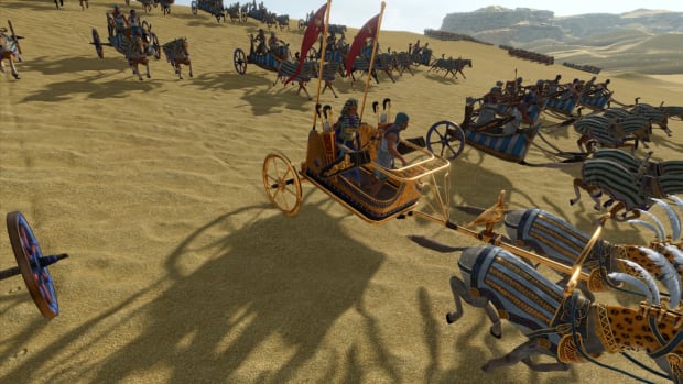 Total War: Pharaoh screenshot of Tausret riding a chariot into battle.