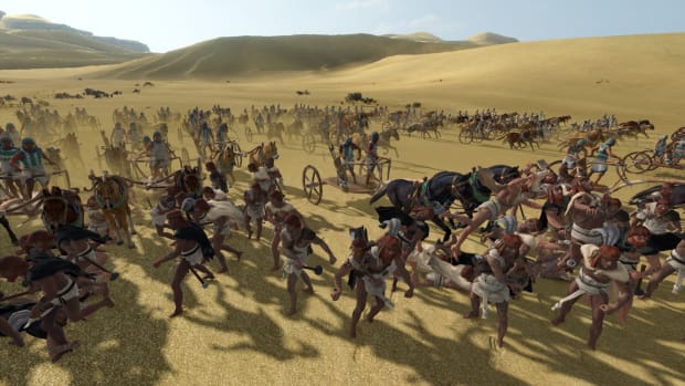 Total War: Pharaoh screenshot of chariots crashing into infantry.