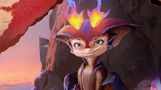 League of Legends mastery cap: A cartoon-like lizard with prominent red ears and two horns of fire on their forehead is shown sitting near a rock pile, wearing a large grin