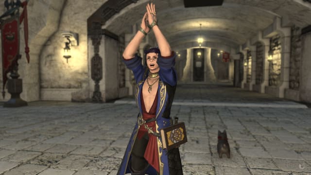 A Final Fantasy 14 Miqo'te wearing a blue robe with gilded stream and a red sash is standing in front of a stone tunnel, clapping his hands