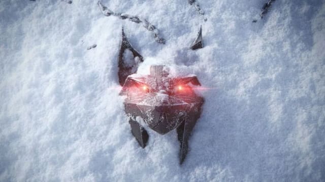 A necklace in the form of a metal cat head with red glowing eyes in the snow.