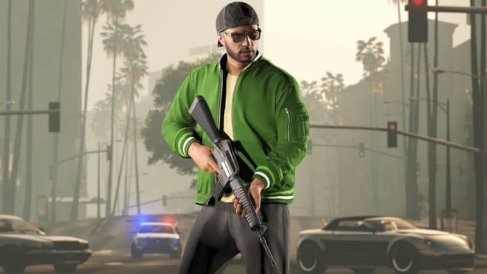 PSA: don’t play GTA Online on PC right now: An animated man wearing a backwards baseball cap and a green varsity jacket is standing in the middle of a street lined with palm trees. In his hand is an assault rifle, and a police car is approaching him