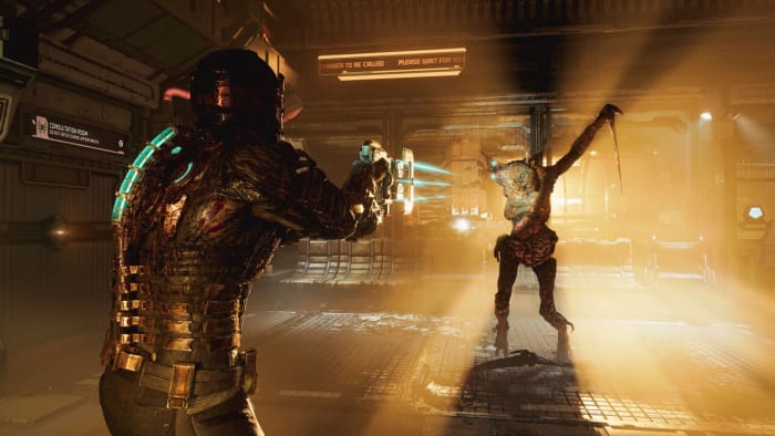 A necromorph alien walks towards a man in armour aiming a gun in the Dead Space remake.