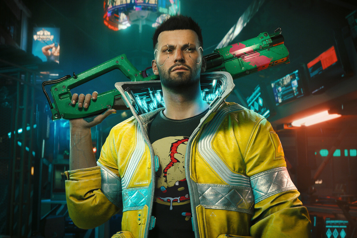 Cyberpunk 2077 Phantom Liberty is CDPR’s most expensive DLC: A man with short dark hair, a growth of stubble on his chin, and electric circuits running around his eyes stands in the middle of a dark street illuminated faintly by dim neon lights.