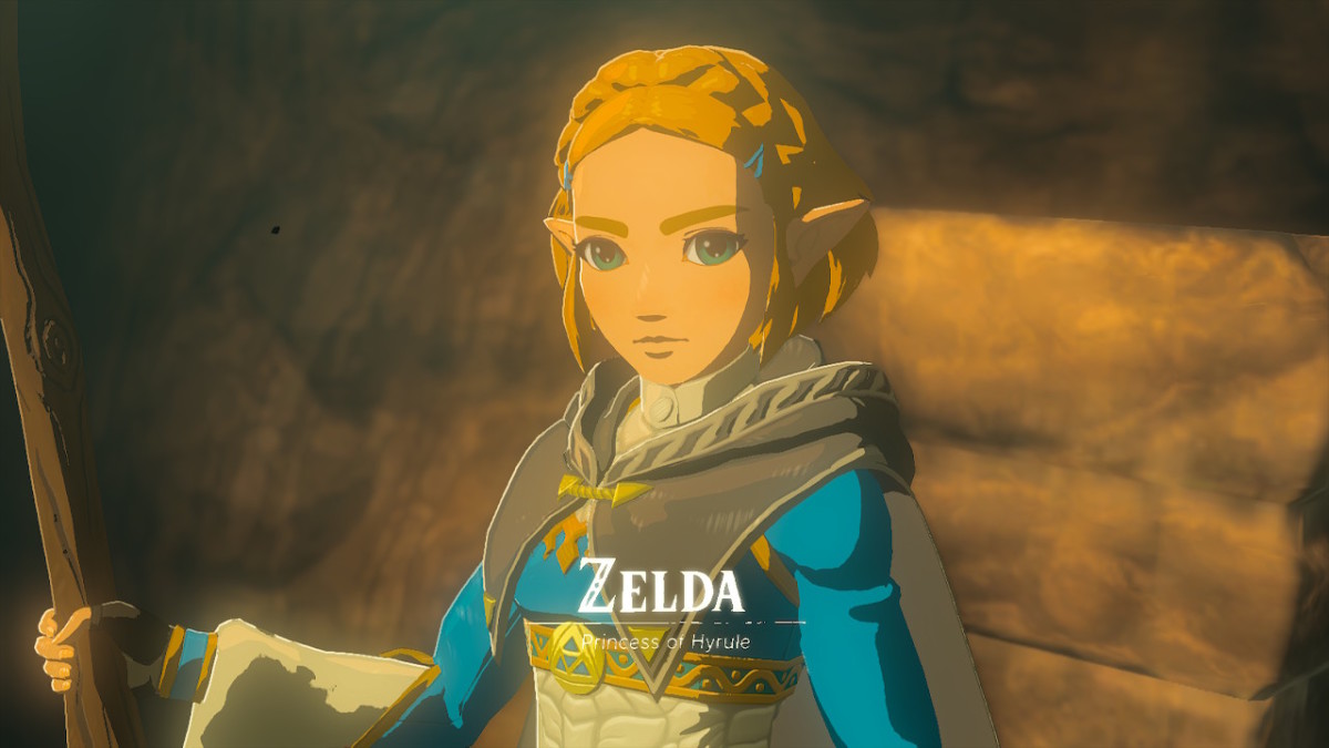 A screenshot of Princess Zelda from The Legend of Zelda: Tears of the Kingdom, looking at the camera. Overlaid is text that says "Zelda - Princess of Hyrule".