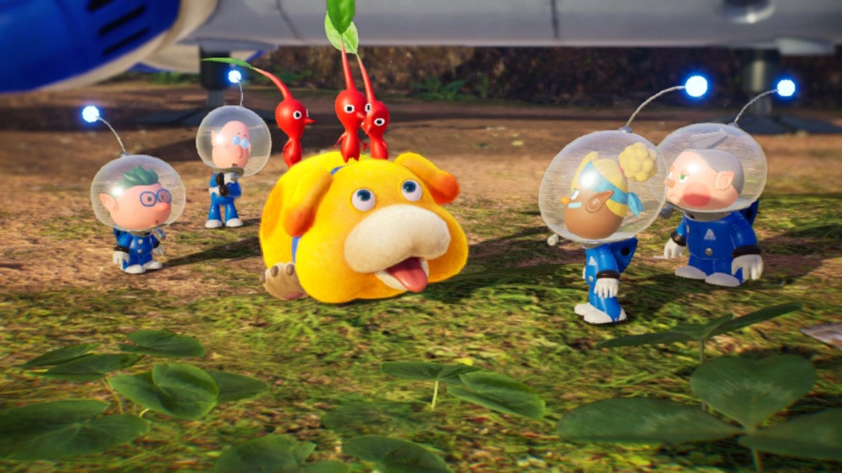 Four small humans in blue spacesuits are standing around a yellow dog, who has three red radishes on his head