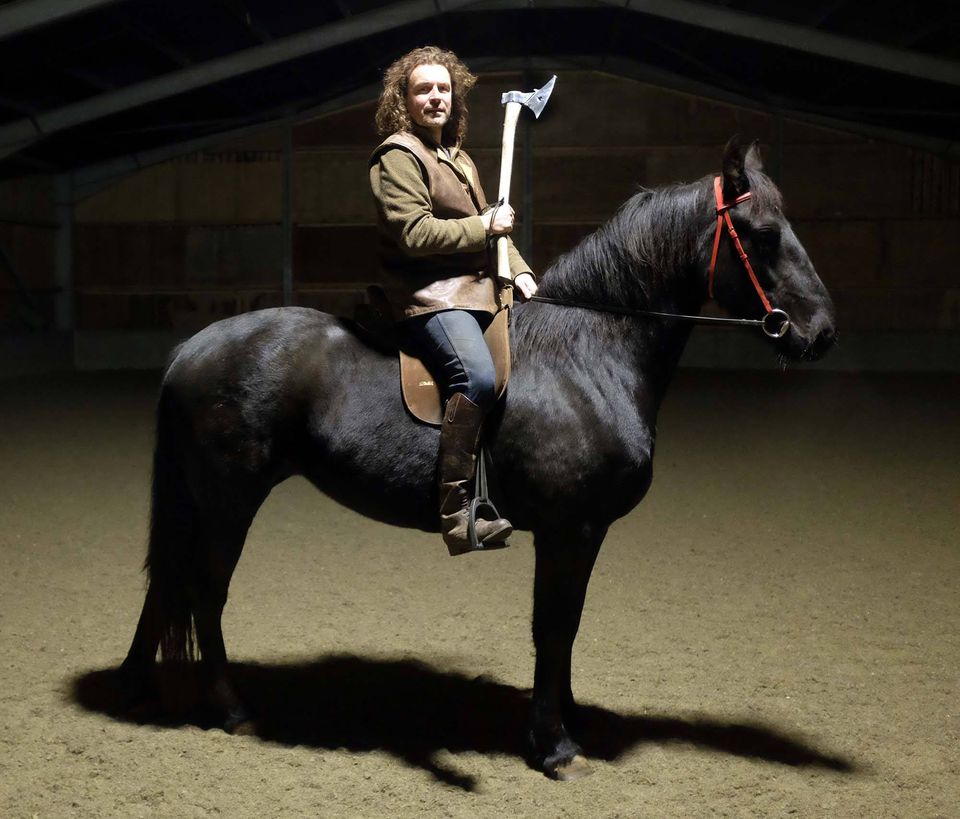 Jason Kingsley on horseback with a war axe.