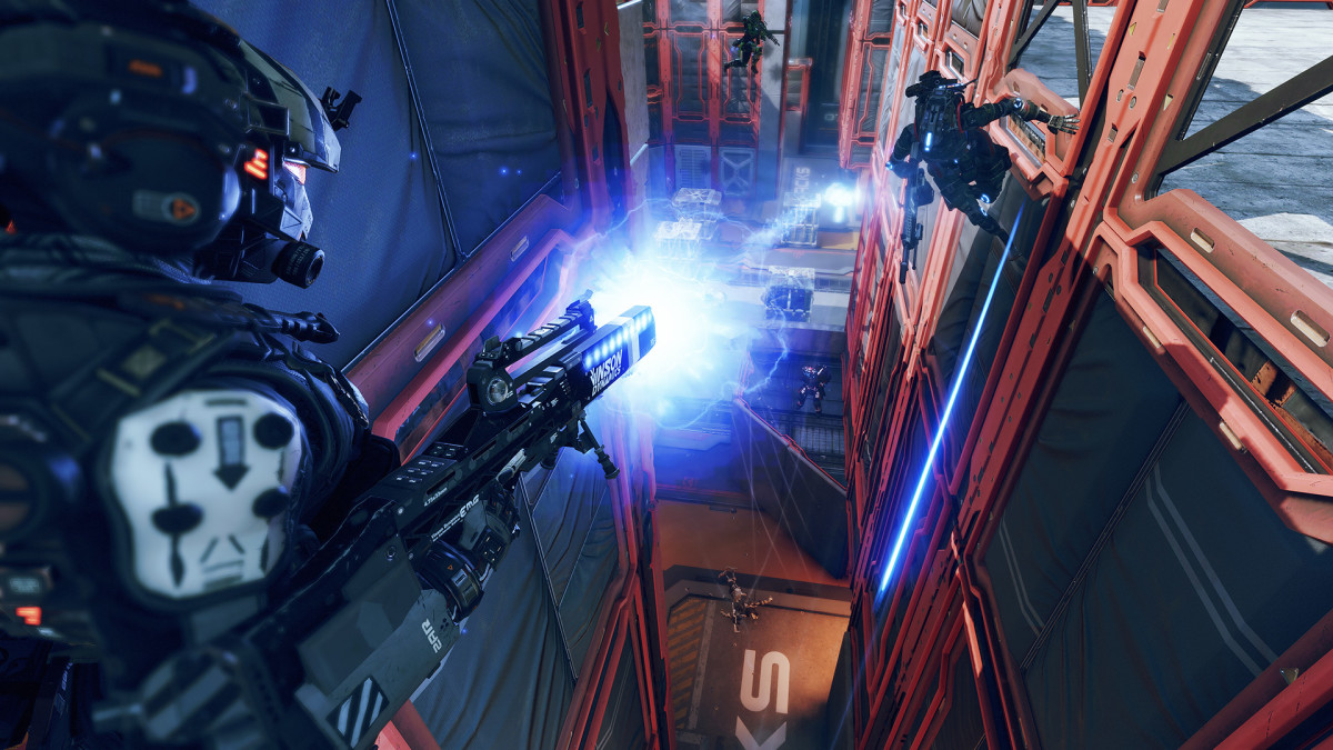 A robot wallruns towards the player as they shoot it down with an electrically charged rifle in Titanfall 2.