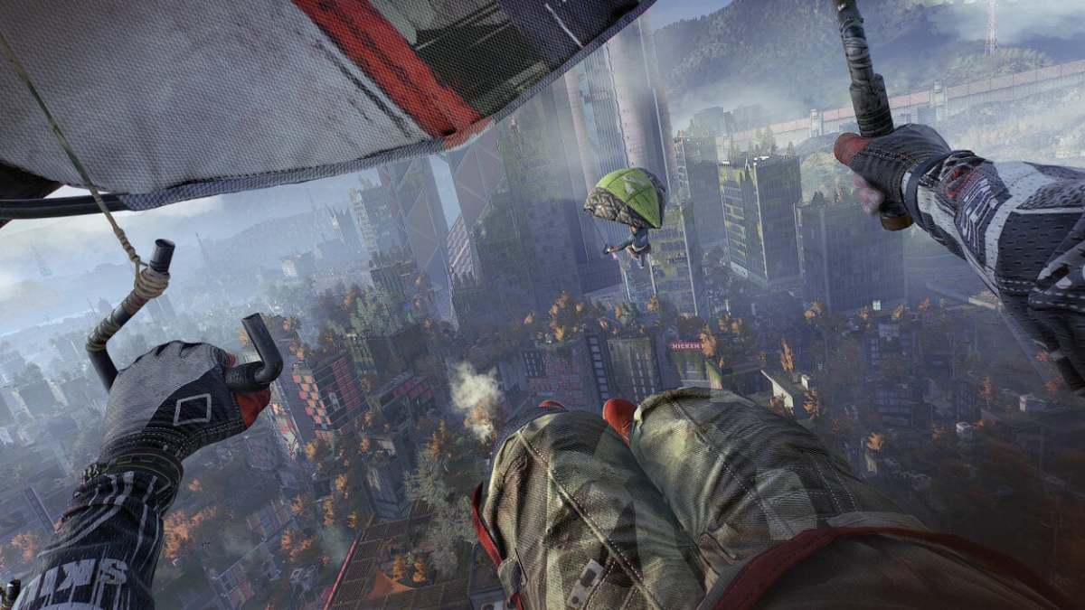 The player paraglides over a city, following another paraglider, in Dying Light 2.