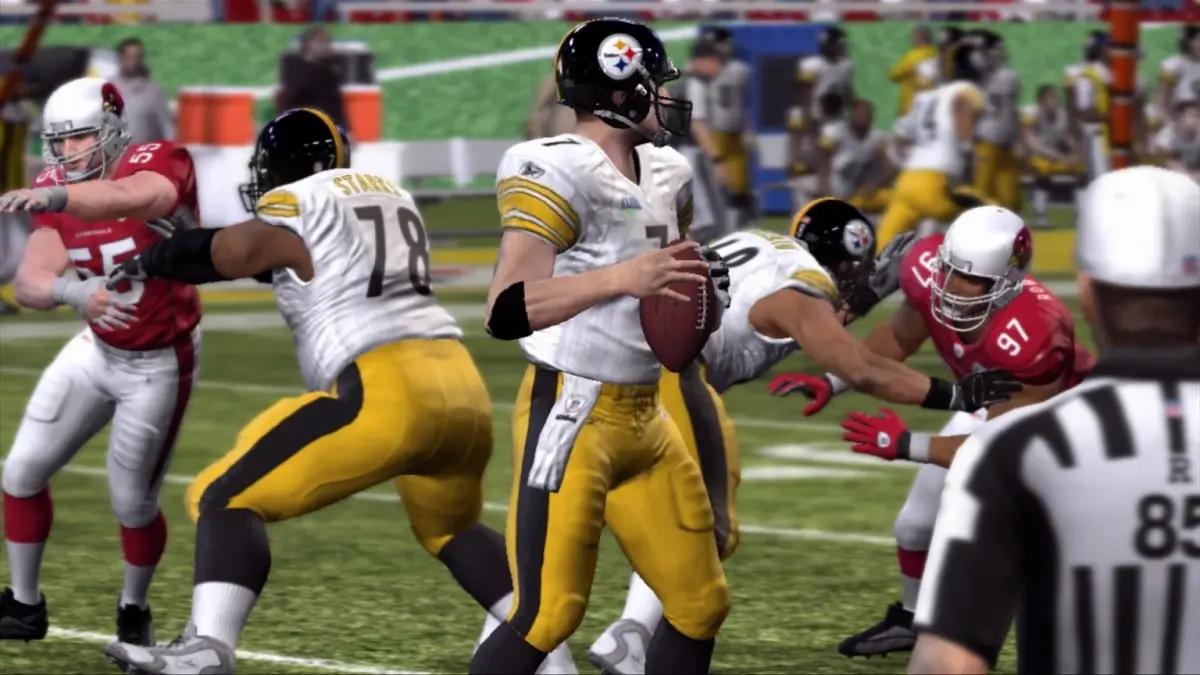 A player readies a throw as attackers are pushed back by defenders in Madden 10.