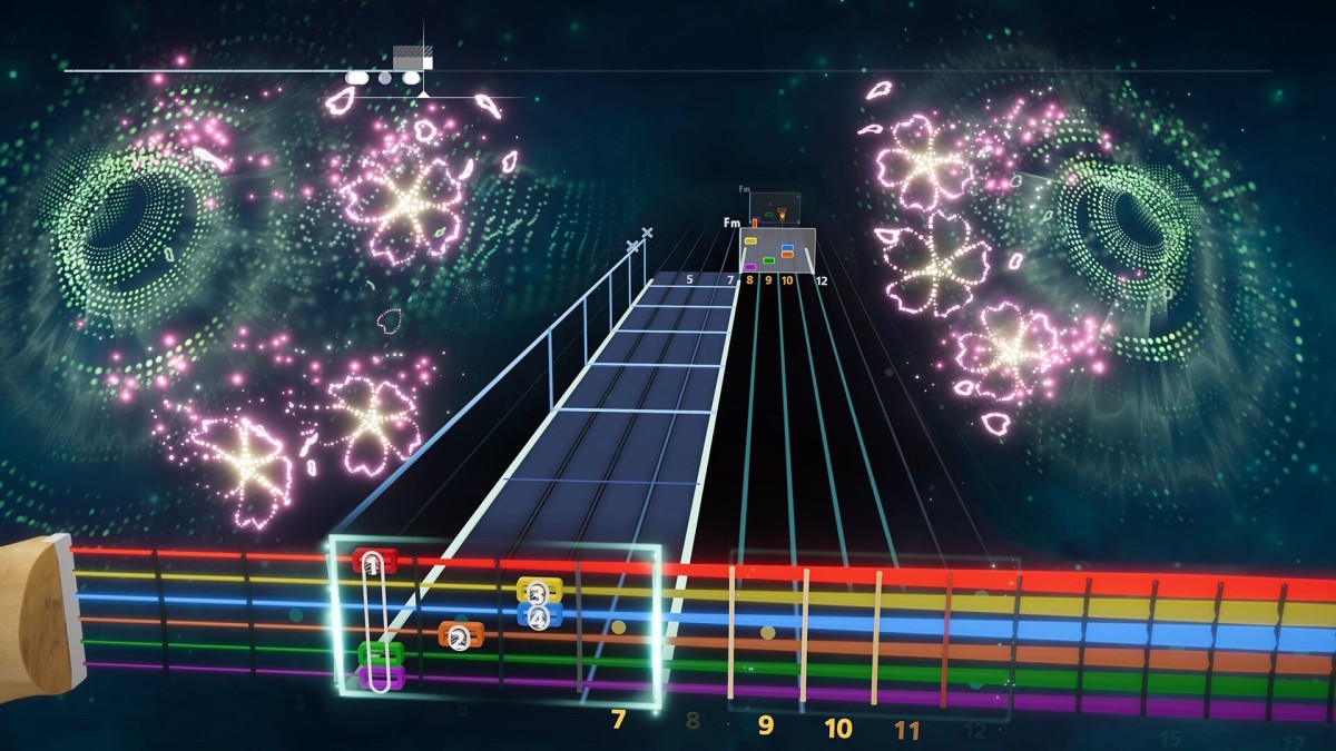 A series of guitar chords are shown, set against a starry background with fireworks exploding in blossom shapes