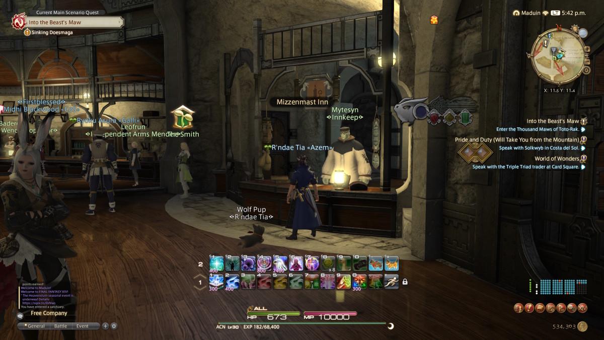A Final Fantasy 14 Miqo'te wearing a blue robe is standing in front of a desk, speaking with an innkeeper.