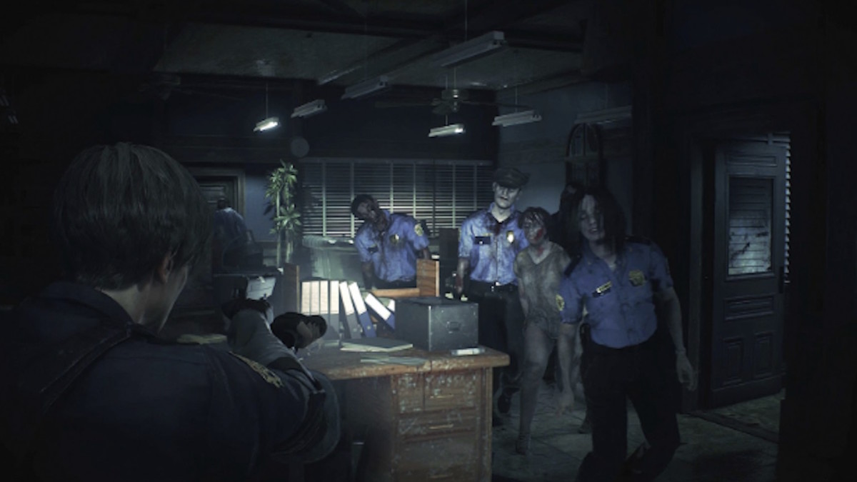 A cadre of zombie police officers ambles forward across an office toward a man carrying a flashlight