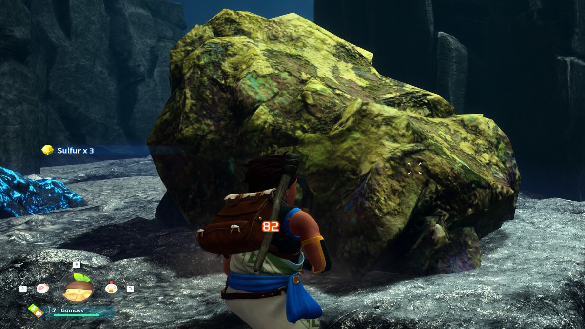 A Palworld sulfur deposit is sitting alone in a large cavern, as a player character mines it with a pickaxe